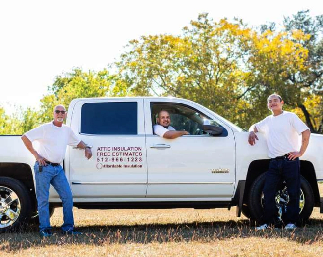 company employees posing on company vehicle